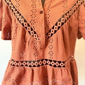 OPULLENCE
PARIS burnt orange eyelet peplum top.